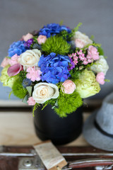 Mixed flowers in the box near the bed
