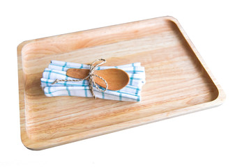 Small Wooden Spoon Tied on a White and Blue Napkin Isolated on White Background