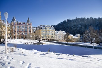 Fototapeta na wymiar Goethe square with snow - sunny winter day in Marianske Lazne (Marienbad) - great famous Bohemian spa town in the west part of the Czech Republic (region Karlovy Vary)