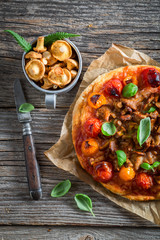 Tasty pizza with chanterelle mushrooms and basil