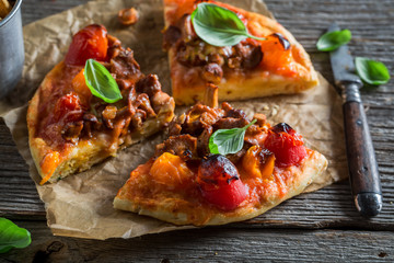 Delicious pizza on old wooden rustic table