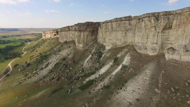 White rocky cliffs, aerial video / Flight along the white rocky mountains with caves and grottoes, aerial video