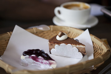 chocolate cake and coffee cup in the background