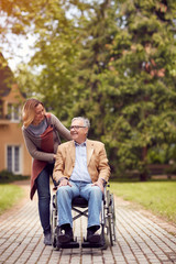 Man on wheelchair with his daughter.