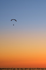 Paraglider in the sky at sunset