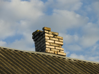 Old brick chimney on the roof