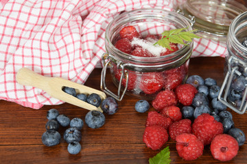 blueberries and raspberries in jars for the winter tea