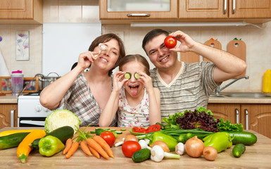 family cooking in kitchen interior at home, fresh fruits and vegetables, healthy food concept, woman, man and children