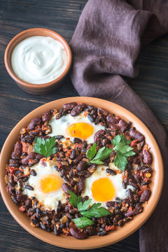 Bowl of chipotle bean chili with baked eggs