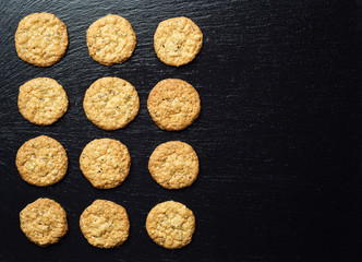 Biscuit sweet cookie background. Domestic stacked butter biscuit pattern concept,close up macro.Homemade cookies on wooden table.Cereal biscuits with the sesame,peanuts,sunflower and amaranth.