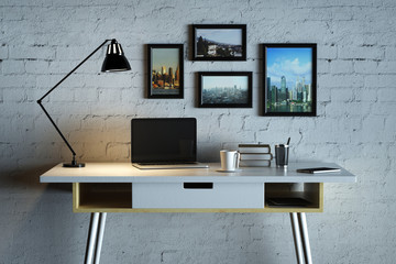 Designer desk with empty laptop