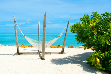 Beautiful landscape with hammock on the sandy beach, Maldives island