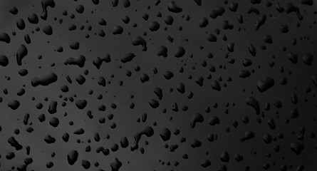 Water drops on black dark surface  texture background