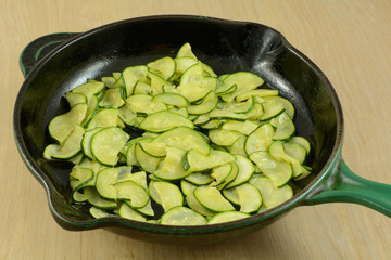 Sauteed sliced zucchini in cast iron frying pan skillet