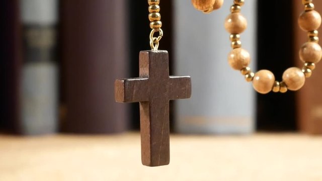 Wooden Rosary Hanging in Front of Library. Panning.