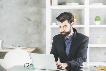 Focused man using laptop