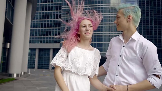 cute young couple with her hair dyed in bright colors of pink and blue