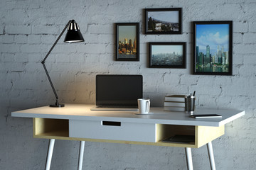 Designer desktop with empty laptop computer