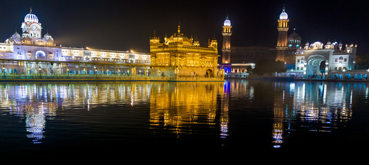 Beautiful Golden temple in Amritsar, Punjab, India is the holiest Gurdwara of Sikhism. Sri Harmandir Sahib (The abode of God), also Sri Darbar Sahib. India tourism. Shining at night with reflections