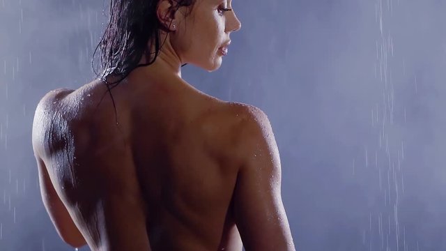 woman taking a shower in slow motion. beautiful girl washing and enjoy yourself under the shower, close up the back