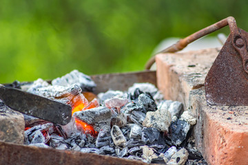 Coals in the smithy in the open air
