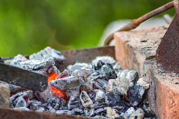 Coals in the smithy in the open air
