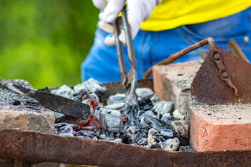 Coals in the smithy in the open air
