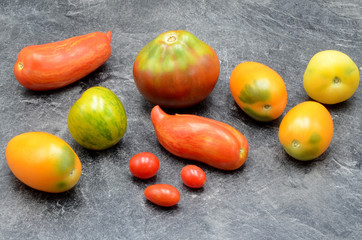 Fototapeta na wymiar Many Tomatos on a stone background photo