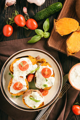 Baked sweet potatoes served with tzatziki dip.