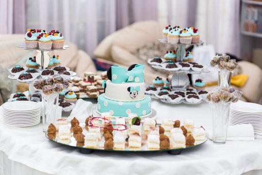 Candy Bar. Delicious sweet buffet with cupcakes. Sweet holiday buffet with cupcakes and other desserts.Table with sweets, candies, dessert,happy birthday concept
