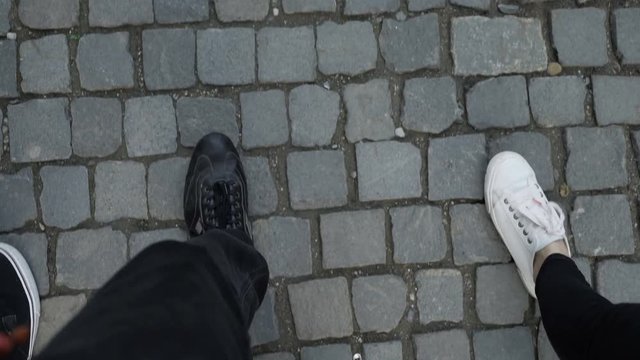 Point of view of three friends feet walking and fooling around