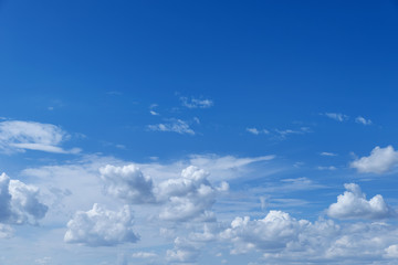 Blue beautiful sky with snow-white clouds of different shapes, background