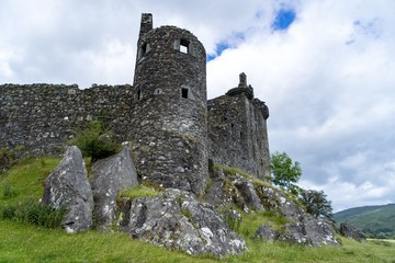 Castle from below cloudy sky rocks ruins