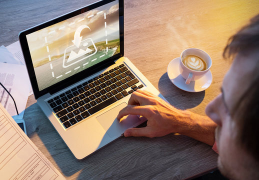 User with Laptop and Paperwork Mockup 1