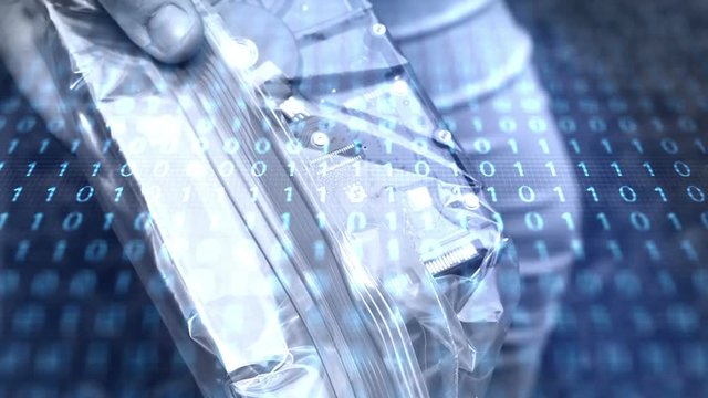 Cyber Crime concept -  a suspicious computer hardrive is held up to camera