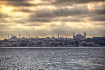 Obraz na płótnie Canvas Blue Mosque and Hagia Sophia view from Halic at cloudy day, yellow effect applied