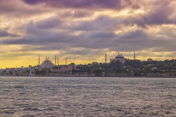 Blue Mosque and Hagia Sophia view from Halic at cloudy day, yellow effect applied