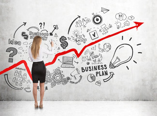 Rear view of a blonde coach business planning