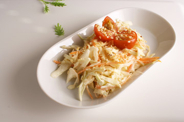 Salad of cabbage and carrots on a light background