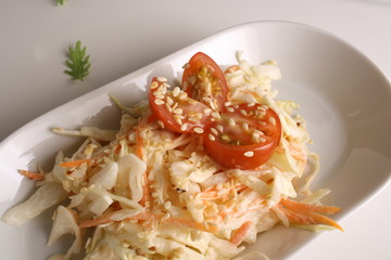 Salad of cabbage and carrots on a light background