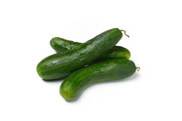 Heap of green cucumbers on white background