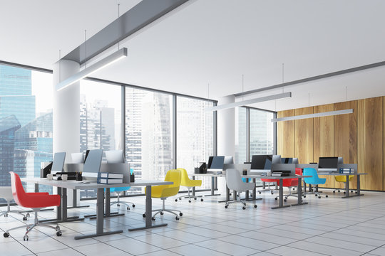Loft downtown office interior, colored chairs side