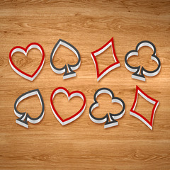 3d playing card suits line art on the wooden background