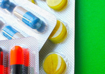 Many different colorful tablets in strips. Medications. Background of medicine from many capsules. Pharmacy.