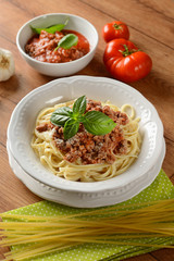 Spaghetti with meat sauce with ingredients around