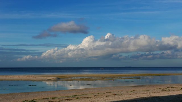 A bright clip from Siquijor white sand beaches. A vague silhouette of the Apo Island can be seen in the horizon. Presented in real time.
