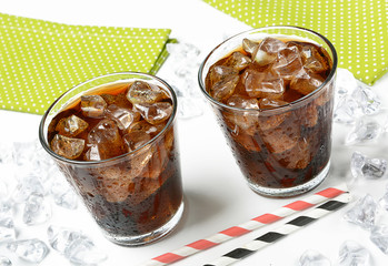 Cola with crushed ice in the glass on white background