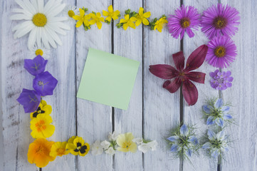 A note on a wooden surface framed by flowers 4