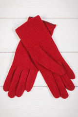 Woolen gloves for woman on white boards, clothing for autumn or winter