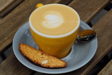 A mug of delicious cappuccino and croutons with nuts
